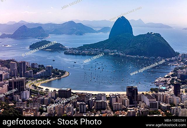View from (Heliport) Mirante Dona Marta of Guanabara Bay & sugarloaf mountain on a clear day with blue sky and mountains in the background and Atlantic Ocean in...