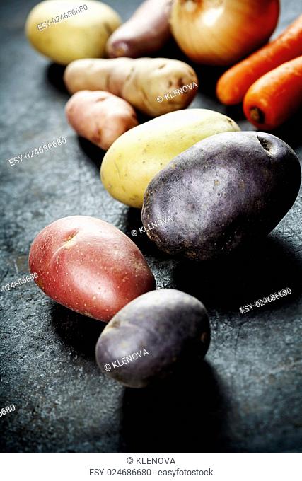 Fresh vegetables (potato, onion, carrot) ready for cooking. Health, vegetarian food or cooking concept. Fresh organic vegetables. Food background