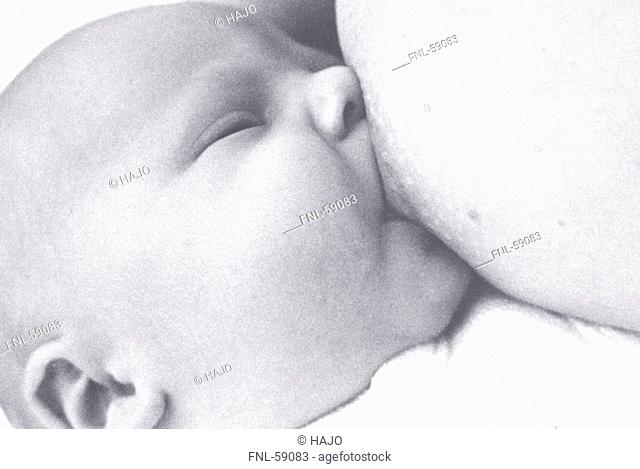 Mother nursing baby, close-up
