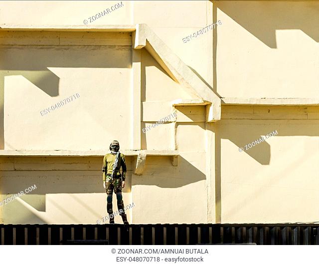Soldier standing with on the wall background
