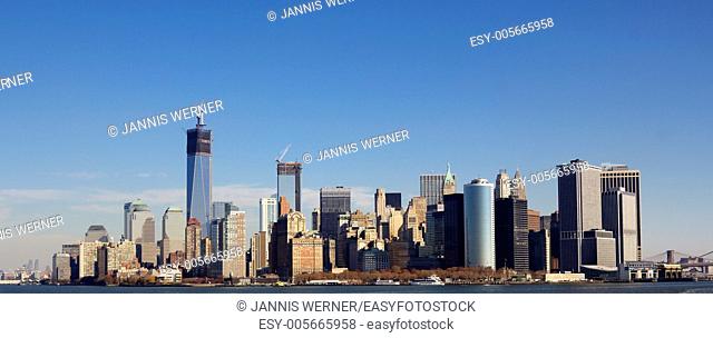 Skyline of New York City at the Southern tip of Manhattan with the new World Trade Center under construction in Fall 2012