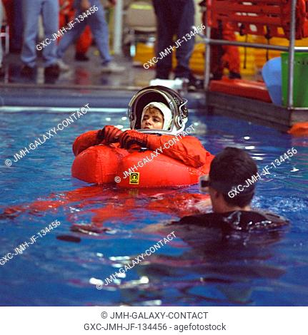 Astronaut Julie Payette is assisted by a SCUBA-equipped diver during emergency bailout training. The STS-96 mission specialist