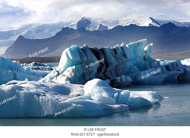 Icebergs on Jokulsarlon Glacial Lagoon, with mountains and glacier behind, South Iceland, Polar Regions