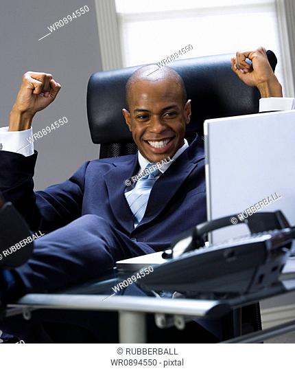 Close-up of a businessman smiling and clenching fists