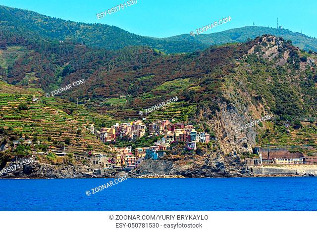 Summer Manarola view from excursion ship. One of five famous villages of Cinque Terre National Park in Liguria, Italy, suspended between Ligurian sea and land...