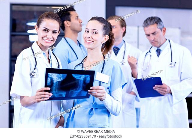 Female doctors checking x ray reports