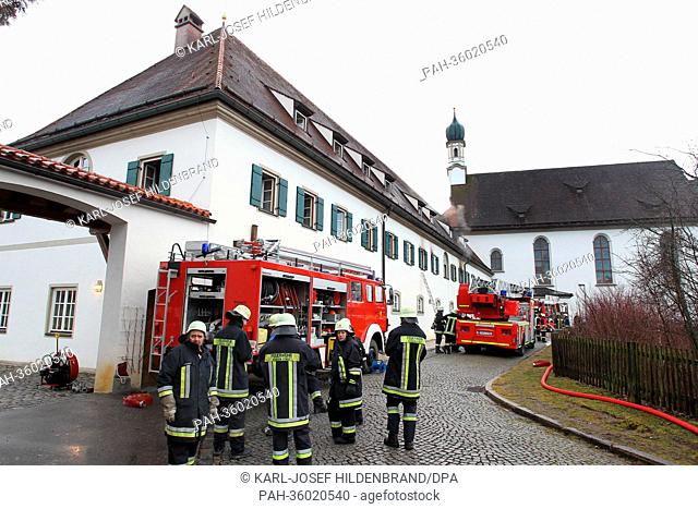 Firemen stand in front of a Franciscan monastery in Fuessen, Germany, 06 January 2013. Fire broke out early in the morning, one friar is criticaly wounded
