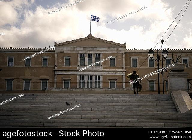 07 November 2020, Greece, Athen: A woman walks up the steps to the parliament building. A three-week lockdown has been in effect throughout Greece since...
