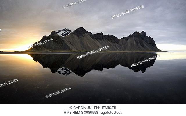 Iceland, Stokksnes, Vestrahorn mountain mirrors in the waters of the Stokksnes bay
