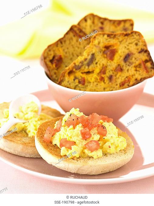 Scrambled eggs on toasted muffins and chorizo savoury cake