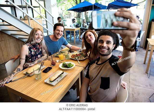 Man taking selfie with friends