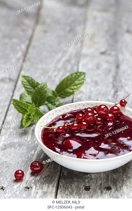 Red groats in a bowl with redcurrants and mint