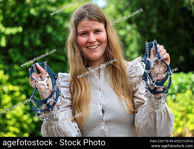 PRODUCTION - 10 July 2023, Bremen: Sarah Winkelmann, expedition adventurer from Bremen, Germany, holds spikes she used during her expedition in her garden