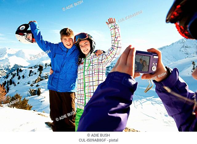 Girl photographing siblings, Les Arcs, Haute-Savoie, France