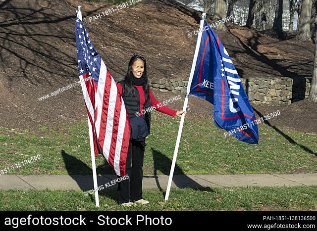 A demonstrator shows support for United States President Donald J. Trump as he arrives at Trump National Golf Club in Sterling, VA, December 13, 2020