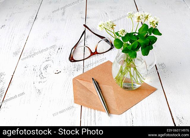 Summer mood with white clover on wooden table