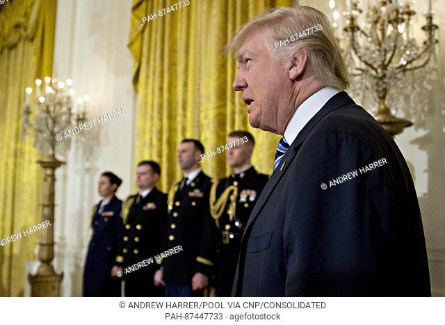 United States President Donald Trump arrives to a swearing in ceremony of White House senior staff in the East Room of the White House in Washington, D