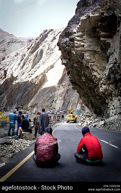 The group of truck drivers waiting when the road will be clear because of landslide