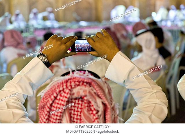 Qatar - Doha - Souq Waqif - Qatari recording an outdoor concert with mobile phones