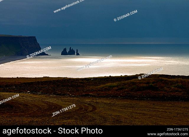 Rock stack at the southern coast of Iceland and the Atlantic Ocean as seen from Dyrhólaey cliffs. South Iceland