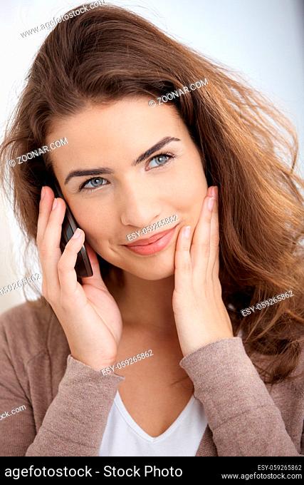 Beautiful young girl talking on mobile phone, smiling