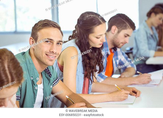Fashion student smiling at camera in class
