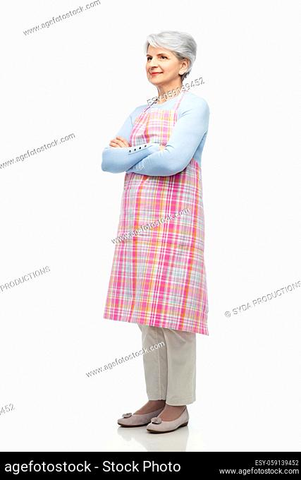 portrait of smiling senior woman in apron