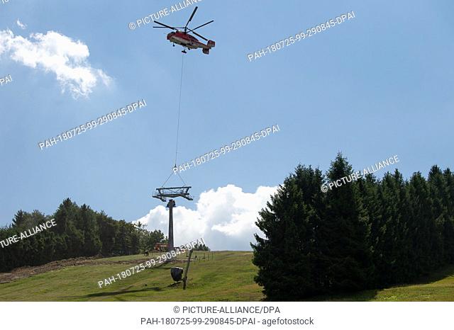 25 July 2018, Willingen, Germany: Parts of a chairlift support of the new 8-seater chairlift ""K1 Willingen"" on the Köhlerhagen runway are transported with the...