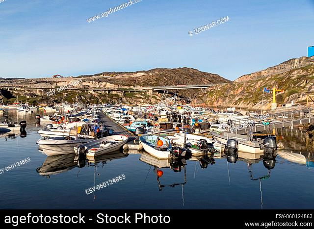 Ilulissat, Greenland - July 01, 2018: Fishing boats anchored at Ilulissat harbor. Ilulissat is located in the Disco Bay just by the Icefjord