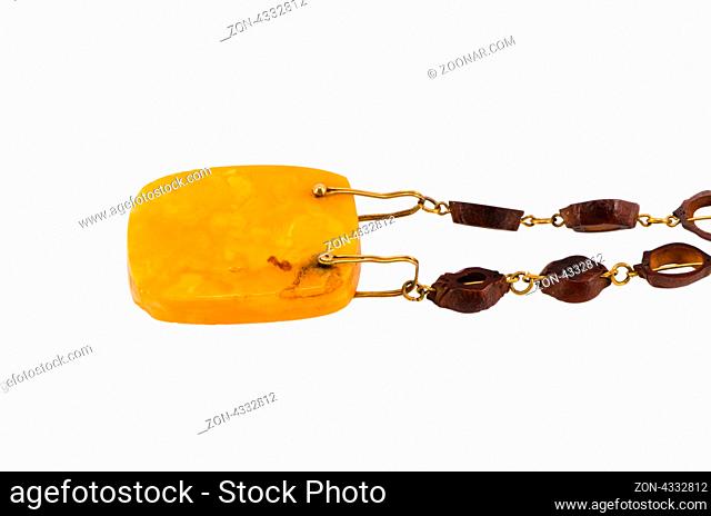 closeup huge piece of baltic gold amber stone on necklace jewelry isolated on white background