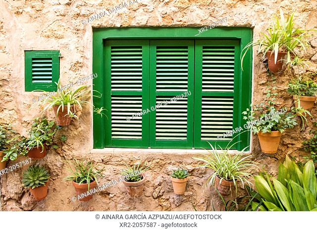 Flower pots on the walls of the typical street of Valldemossa village, Mallorca