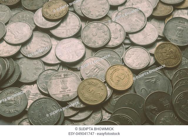 Stock pile of Hundred number 1, 10, 5 Indian rupee metal coin currency on isolated background. Financial, economy, investment concept