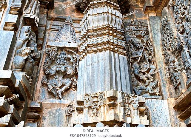 Ornate wall panel reliefs depicting, from left, dancing Kali, a form of Durga, and Shiva dancing on demon, Andhakasura, Chennakesava temple, Belur, Karnataka