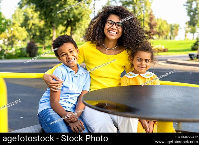 Beautiful happy african american family bonding at the park - Black family having fun outdoors