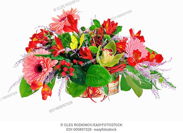Floral arrangement from lilies, cloves and orchids in cardboard chest on white