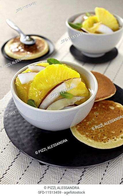 Pineapple and coconut salad with ginger, caramel and pancakes (Asia)