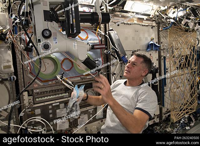 NASA astronaut and Expedition 65 Flight Engineer Shane Kimbrough sets up a microscope in the U.S. Destiny laboratory module to observe and photograph samples...