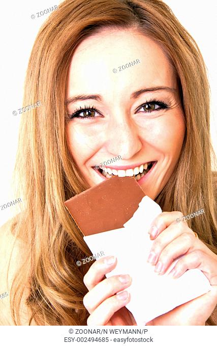 Young woman eats chocolate