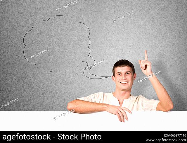 Portrait of handsome male holding blank white ad board