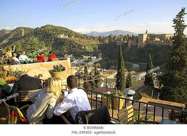 Tourists sitting in balcony, Granada, Andalusia, Spain