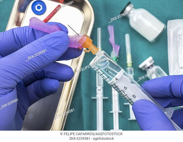 Nurse preparing hospital medication, needle safety closure, conceptual image, horizontal composition