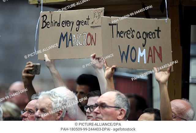 09 May 2018, Germany, Aachen: Visitors holding signs for the visit of the French president Macron at a citizens' fair. Macron is receiving the Charlemagne prize...