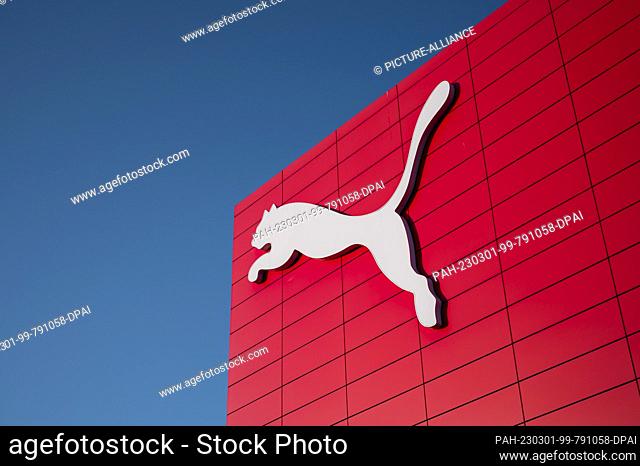 01 March 2023, Bavaria, Herzogenaurach: The Puma logo on the exterior of the brand store. The eternal competition between sporting goods manufacturers in the...
