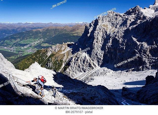 Climber heading to the Alpinisteig or Strada degli Alpini via ferrata, above the Talschlusshuette or Rifugio Fondovalle, at Mt Elferscharte or Forcella Undici