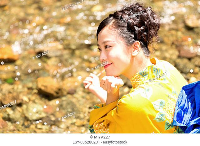 attractive asian woman wearing traditional Japanese casual summer kimono called ""Yukata""