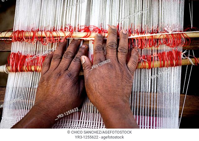 A woman weaves a shawl outside her home in San Andrés Tzicuilan, on the outskirts of Cuetzalan del Progreso, Mexico. Cuetzalan is a small picturesque market...