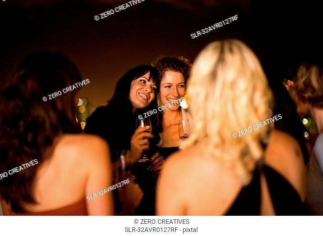 Women smiling at party at night