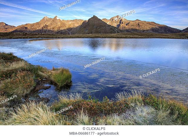 Mount Cardine and Peak Tambò are reflected in Lake Andossi at sunrise Chiavenna Valley Valtellina Lombardy Italy Europe