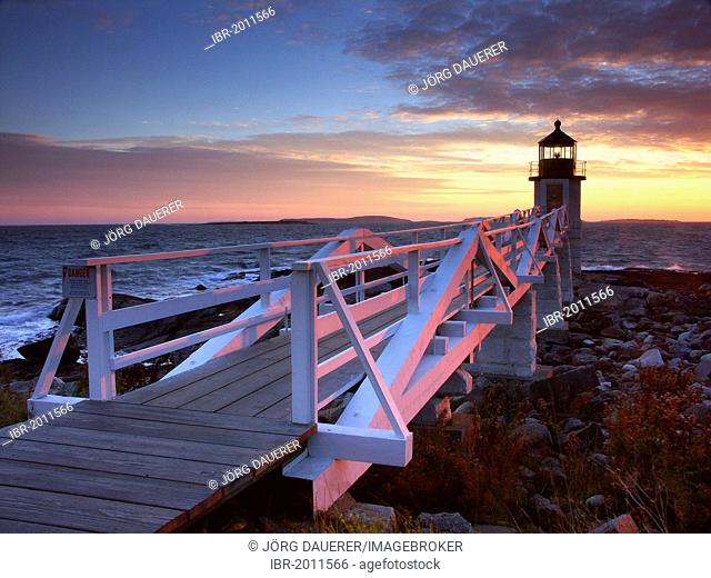 Spectacular sunset behind Marshall Point Lighthouse in Port Clyde, Maine, USA