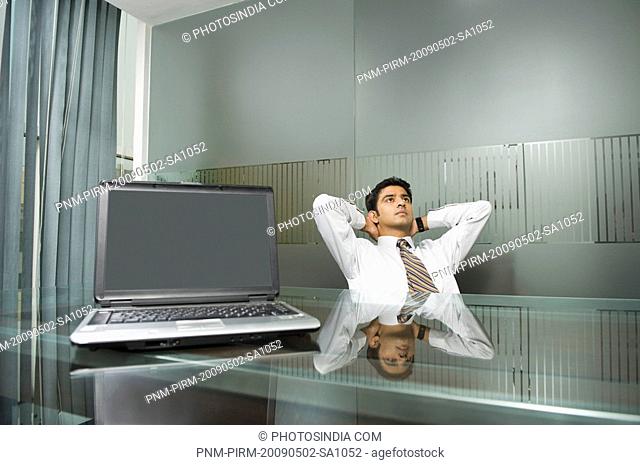 Businessman day dreaming in an office